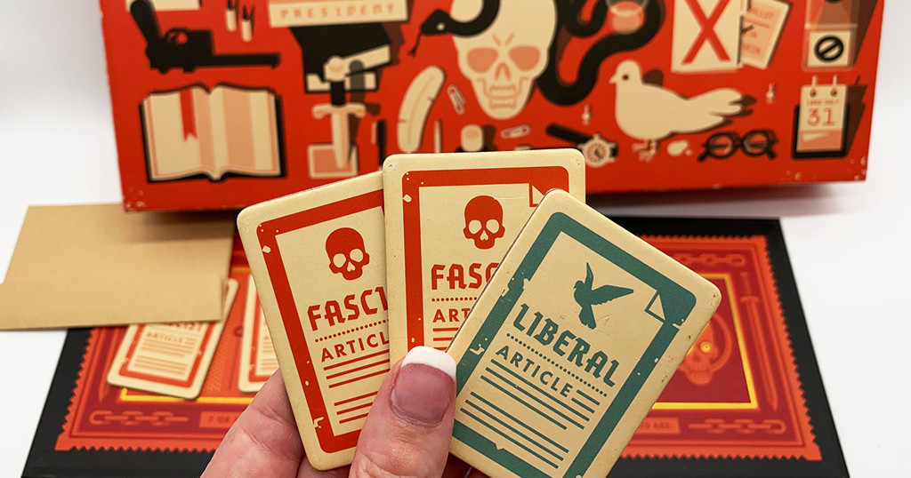 Secret Hitler game set up holding three policy cards