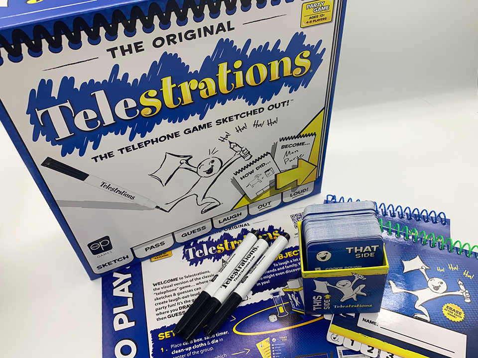 telestrations game box with components that include rule book, markers, cards and sketch books